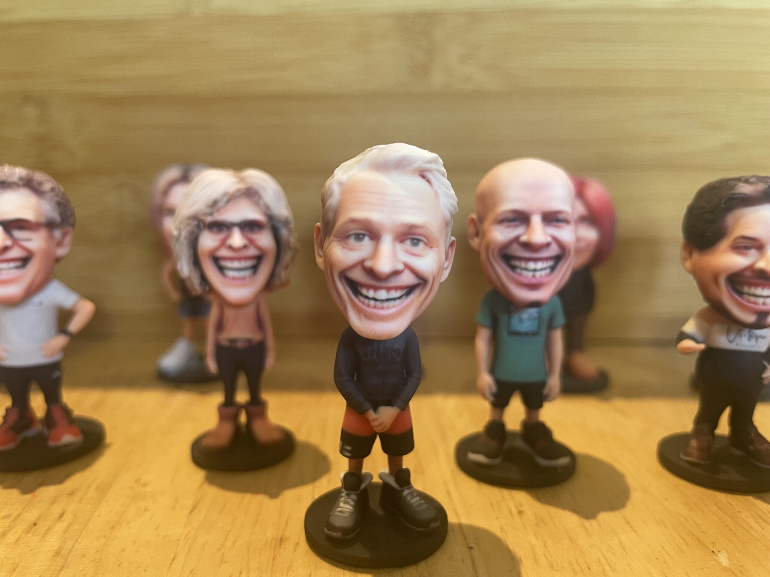 Close-up of two custom bobblehead figurines
