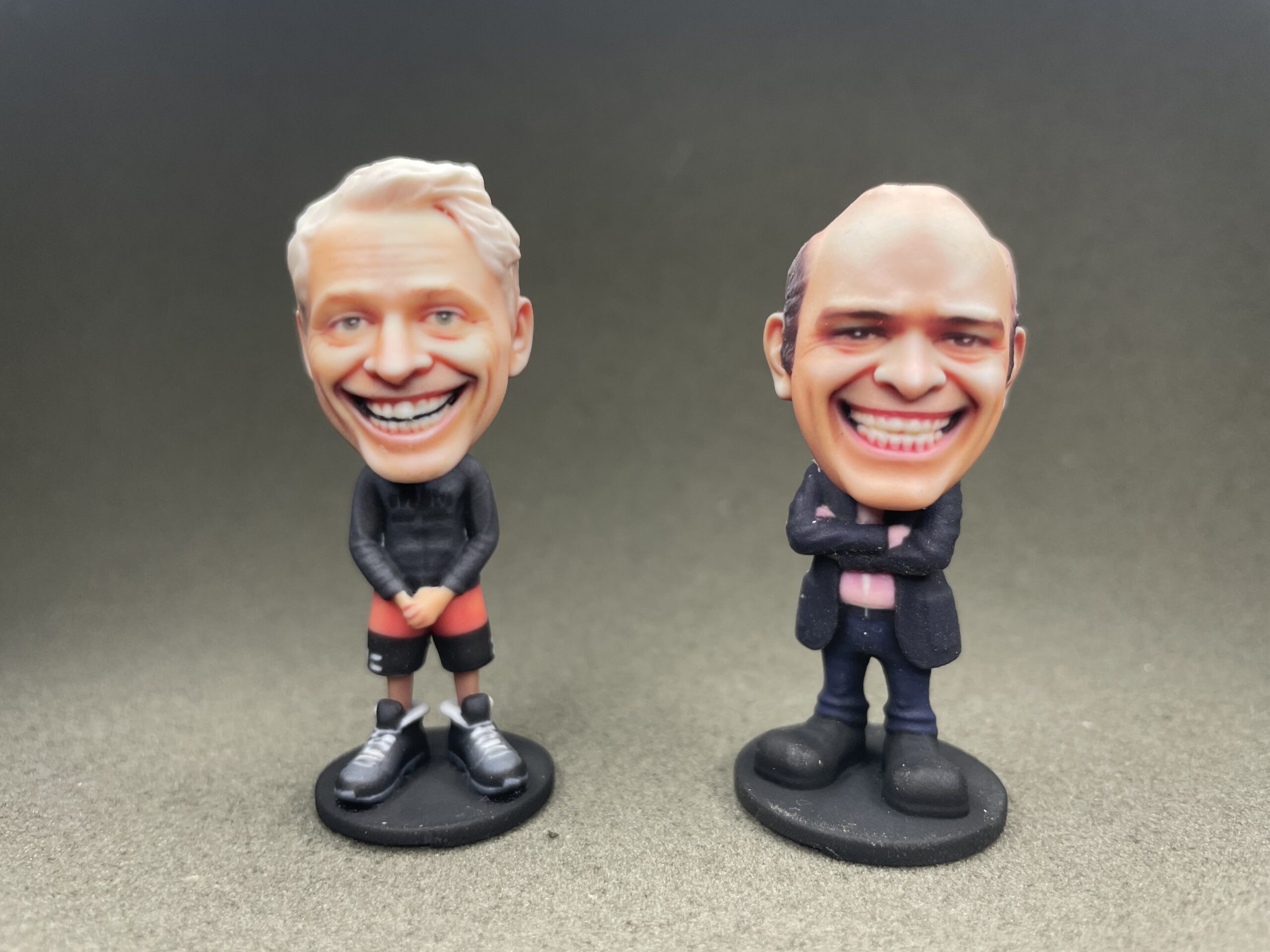 Two custom bobblehead figurines side by side