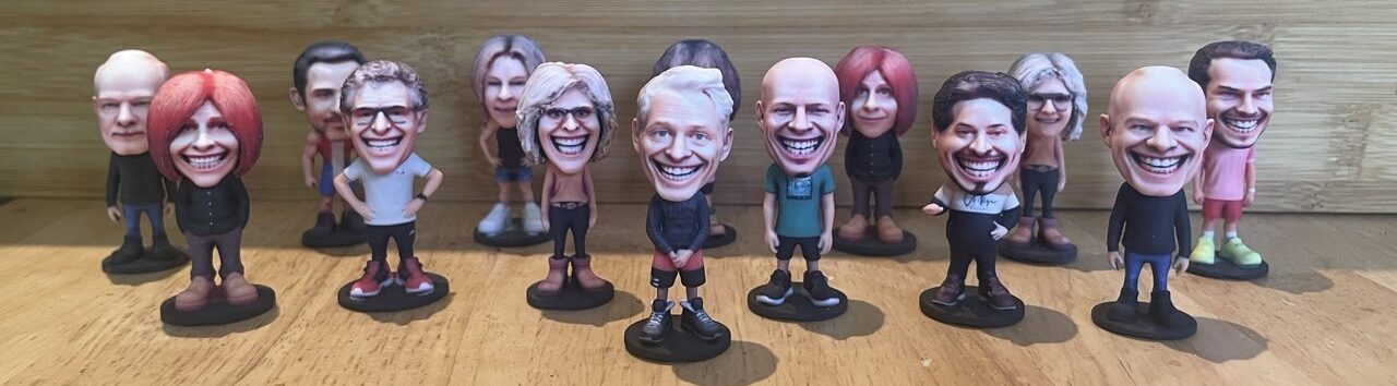 A custom bobblehead figurine surrounded by a row of other figurines